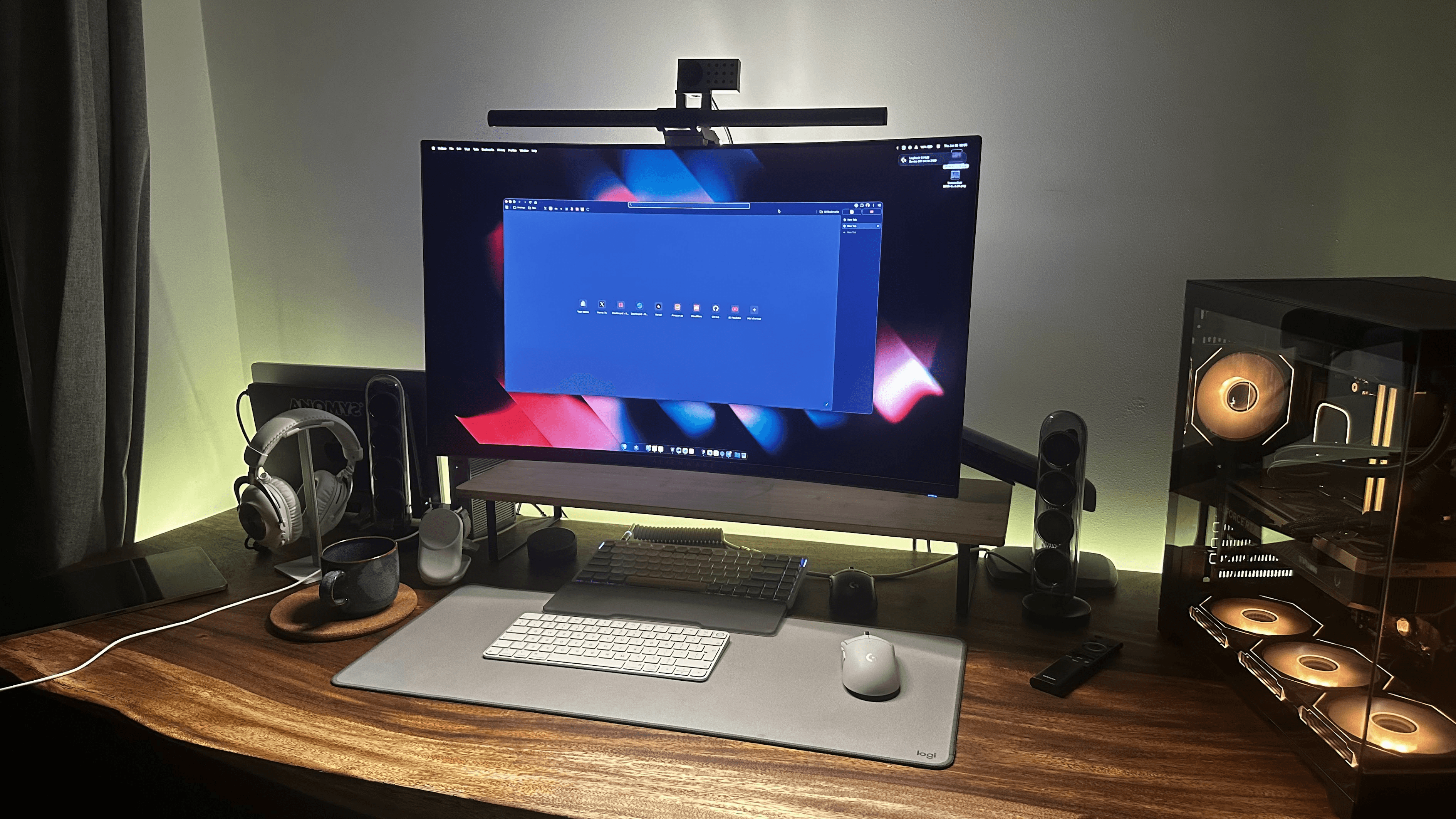 Desk setup with an ultrawide monitor, keyboard, speakers and desktop PC